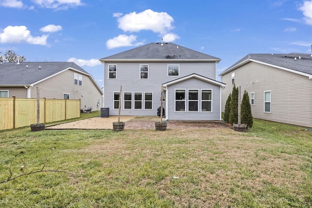 back of house featuring cooling unit, a yard, and a patio