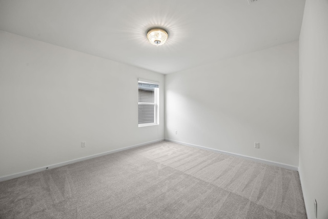 empty room featuring light colored carpet