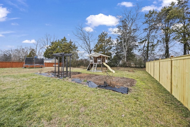 view of yard featuring a playground and a trampoline