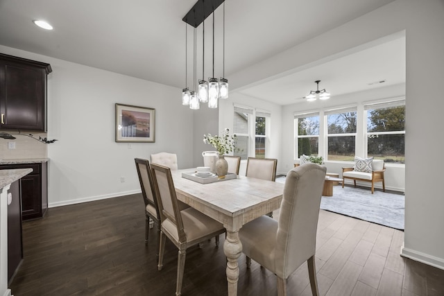 dining space featuring dark hardwood / wood-style floors and ceiling fan