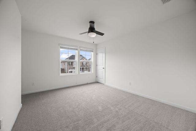 carpeted spare room with ceiling fan