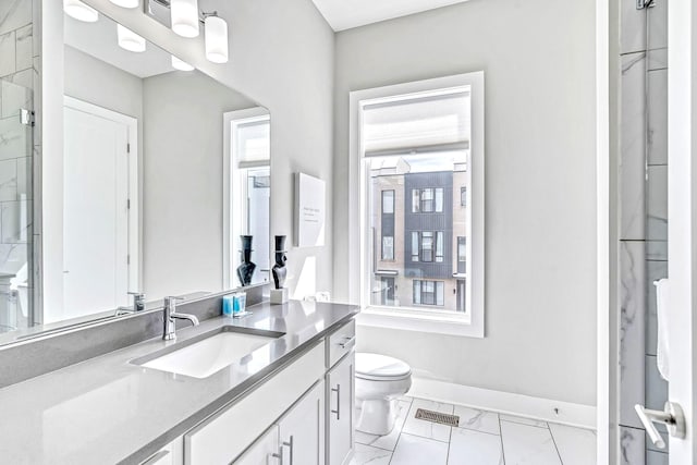 bathroom featuring vanity, toilet, and walk in shower