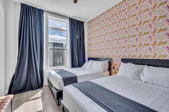 bedroom with light wood-type flooring and ceiling fan