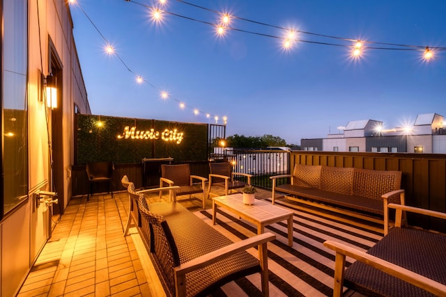 deck at dusk with an outdoor hangout area