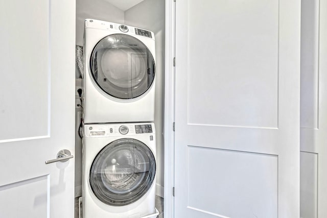 laundry area with stacked washer / dryer