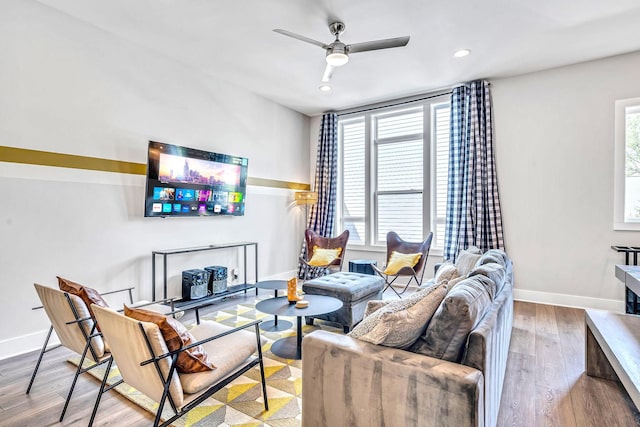 living room with light hardwood / wood-style floors and ceiling fan