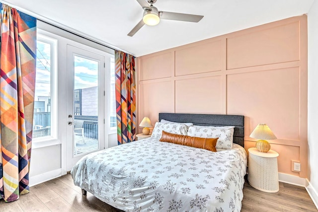 bedroom featuring access to exterior, hardwood / wood-style floors, and ceiling fan