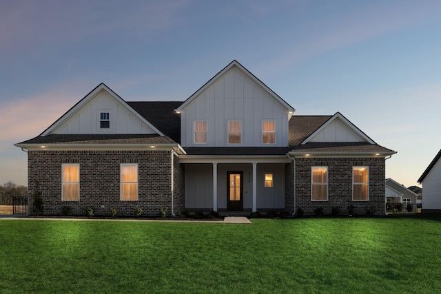 view of front of house with a porch and a lawn