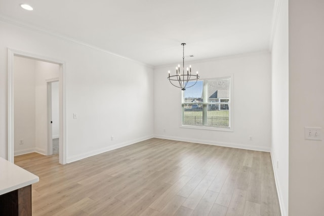 unfurnished dining area featuring a notable chandelier, light wood-type flooring, and ornamental molding