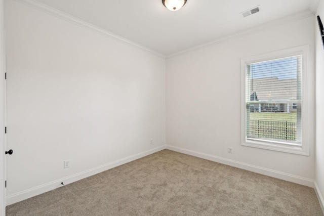 carpeted spare room featuring crown molding