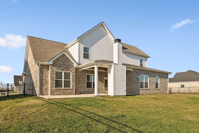 back of property featuring a lawn and a patio area