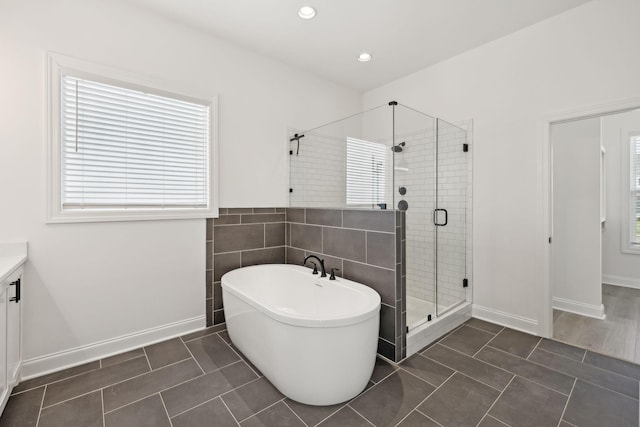 bathroom with tile patterned flooring, shower with separate bathtub, and vanity