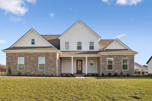 view of front of home with a front yard and covered porch