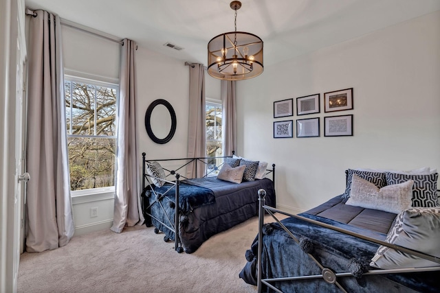 bedroom featuring carpet floors and a chandelier