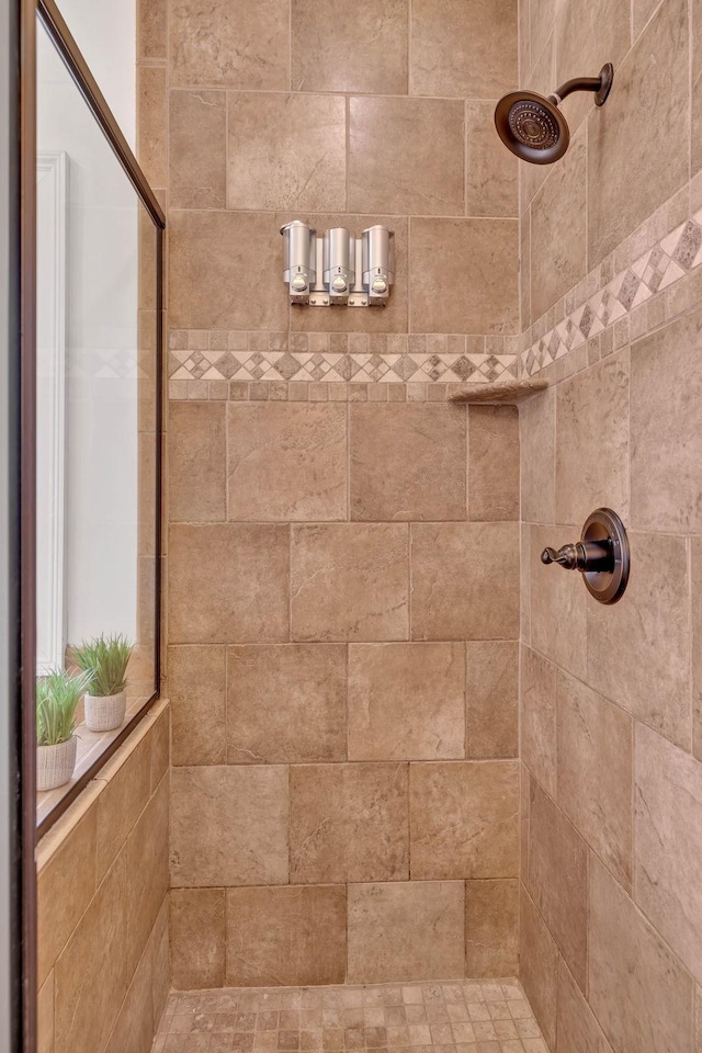 bathroom with tiled shower