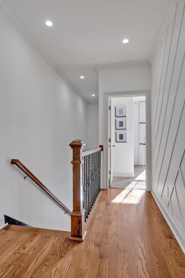 corridor featuring light hardwood / wood-style flooring and crown molding