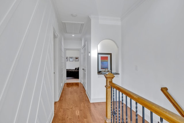 corridor featuring ornamental molding and light hardwood / wood-style flooring