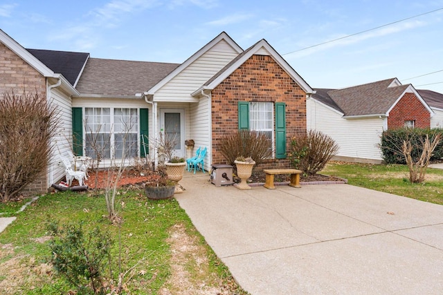 view of front of home with a patio area and a front yard