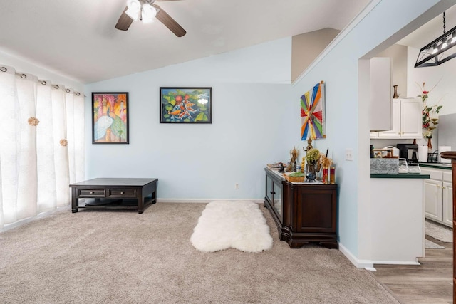 interior space featuring carpet flooring, ceiling fan, and lofted ceiling