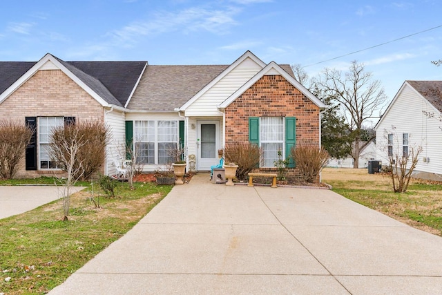 view of front of property with a front lawn and cooling unit