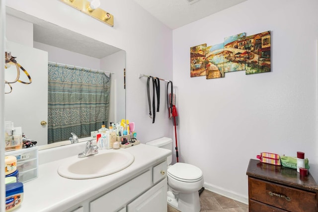 bathroom with vanity, toilet, and curtained shower