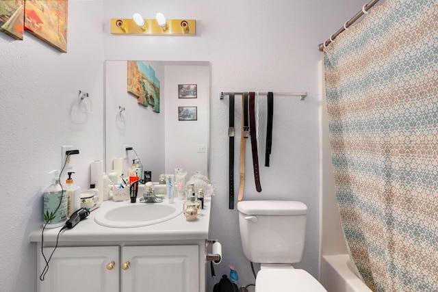 full bathroom with vanity, shower / bath combination with curtain, and toilet