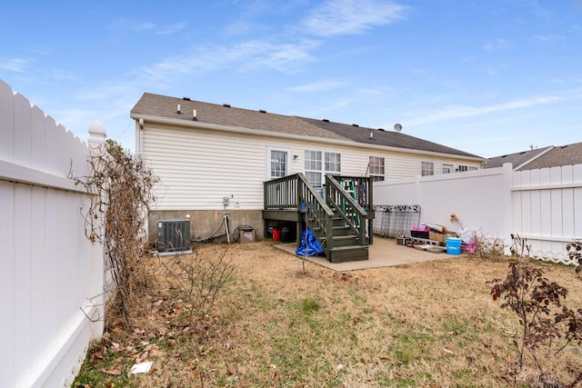 rear view of property with a patio area, central air condition unit, and a wooden deck