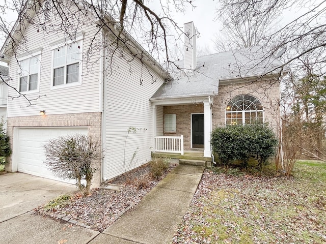 view of front of house with a porch and a garage