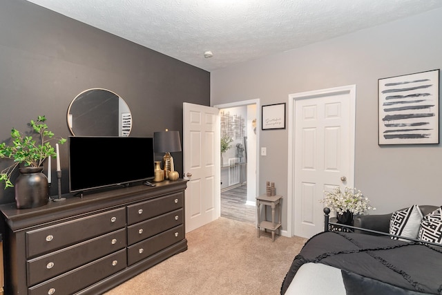 carpeted bedroom featuring a textured ceiling