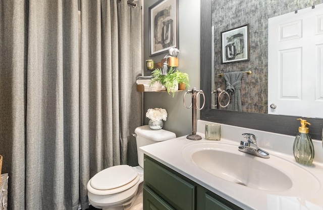 bathroom featuring toilet and vanity