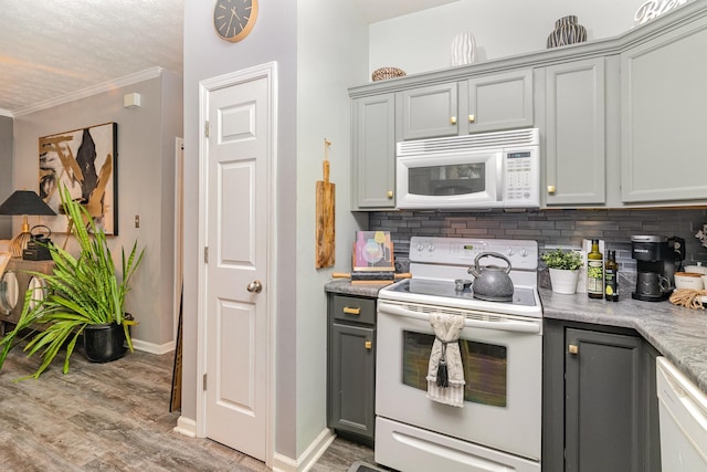 kitchen featuring white appliances, gray cabinets, and ornamental molding