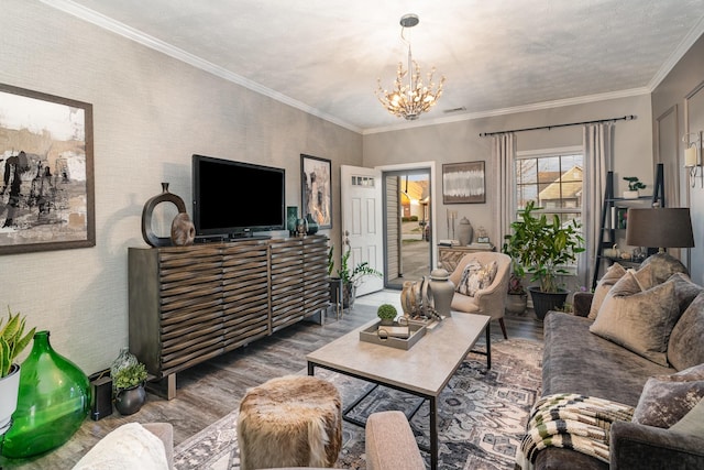 living room featuring hardwood / wood-style floors, a textured ceiling, a chandelier, and crown molding