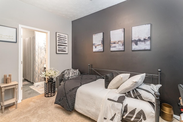 carpeted bedroom featuring a textured ceiling