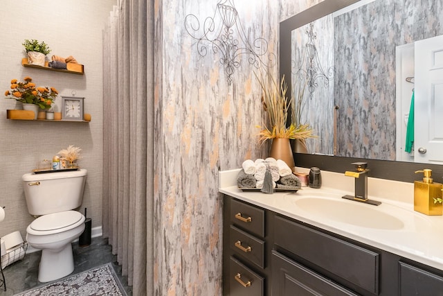 bathroom with toilet and vanity