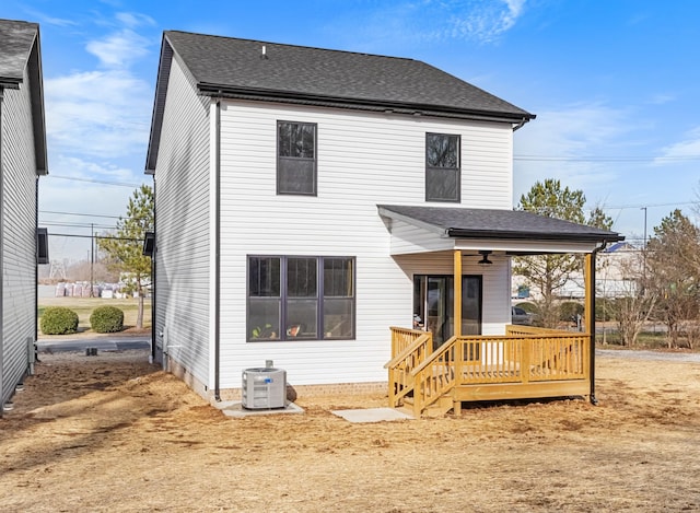 rear view of house featuring ceiling fan and central air condition unit