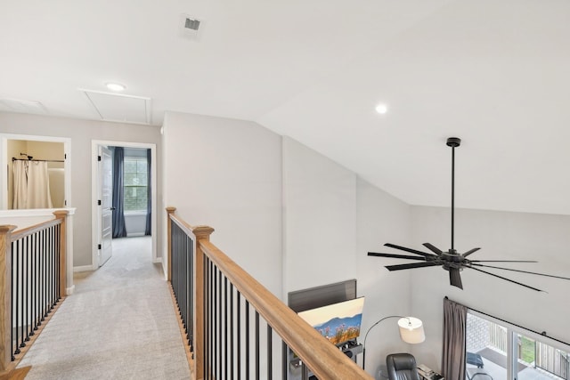 hall with light colored carpet and vaulted ceiling