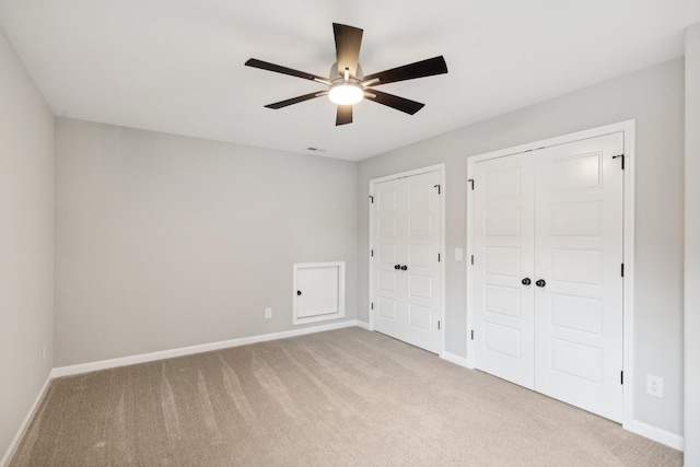 unfurnished bedroom featuring ceiling fan and light carpet