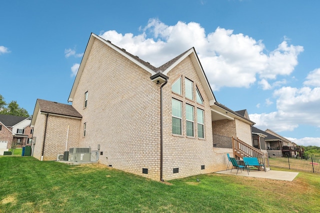 view of property exterior featuring central AC unit, a patio area, and a yard