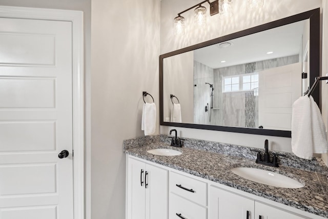 bathroom with vanity and tiled shower