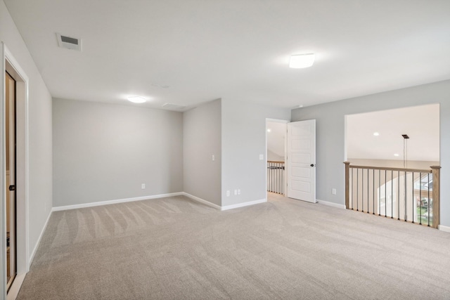 unfurnished room featuring light carpet