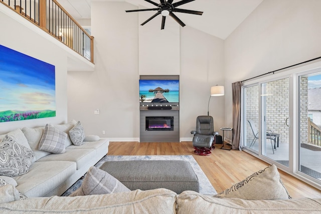 living room with ceiling fan, high vaulted ceiling, and wood-type flooring