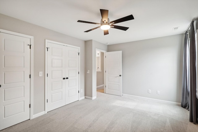 unfurnished bedroom with ceiling fan and light carpet