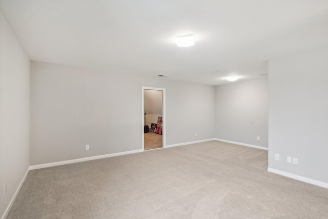 spare room with light colored carpet