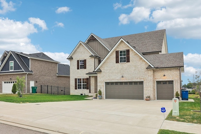 view of front of house featuring a garage and a front lawn