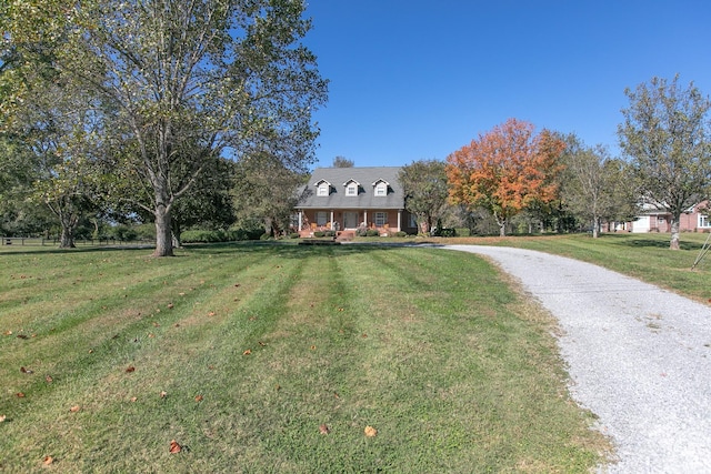 cape cod-style house featuring a front yard and a porch