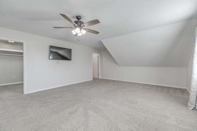 additional living space with carpet flooring, ceiling fan, and lofted ceiling