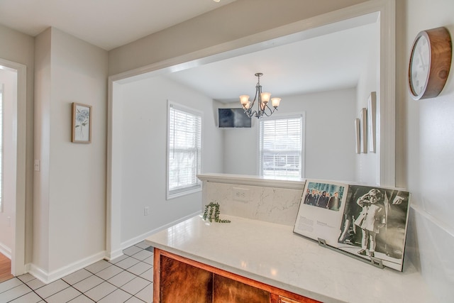 kitchen featuring light tile patterned floors, hanging light fixtures, and an inviting chandelier