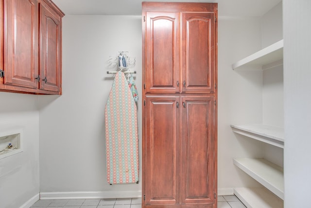 laundry room with cabinets, washer hookup, and light tile patterned floors