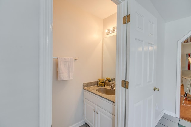 bathroom with tile patterned floors and vanity