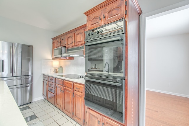 kitchen featuring black appliances and light tile patterned floors